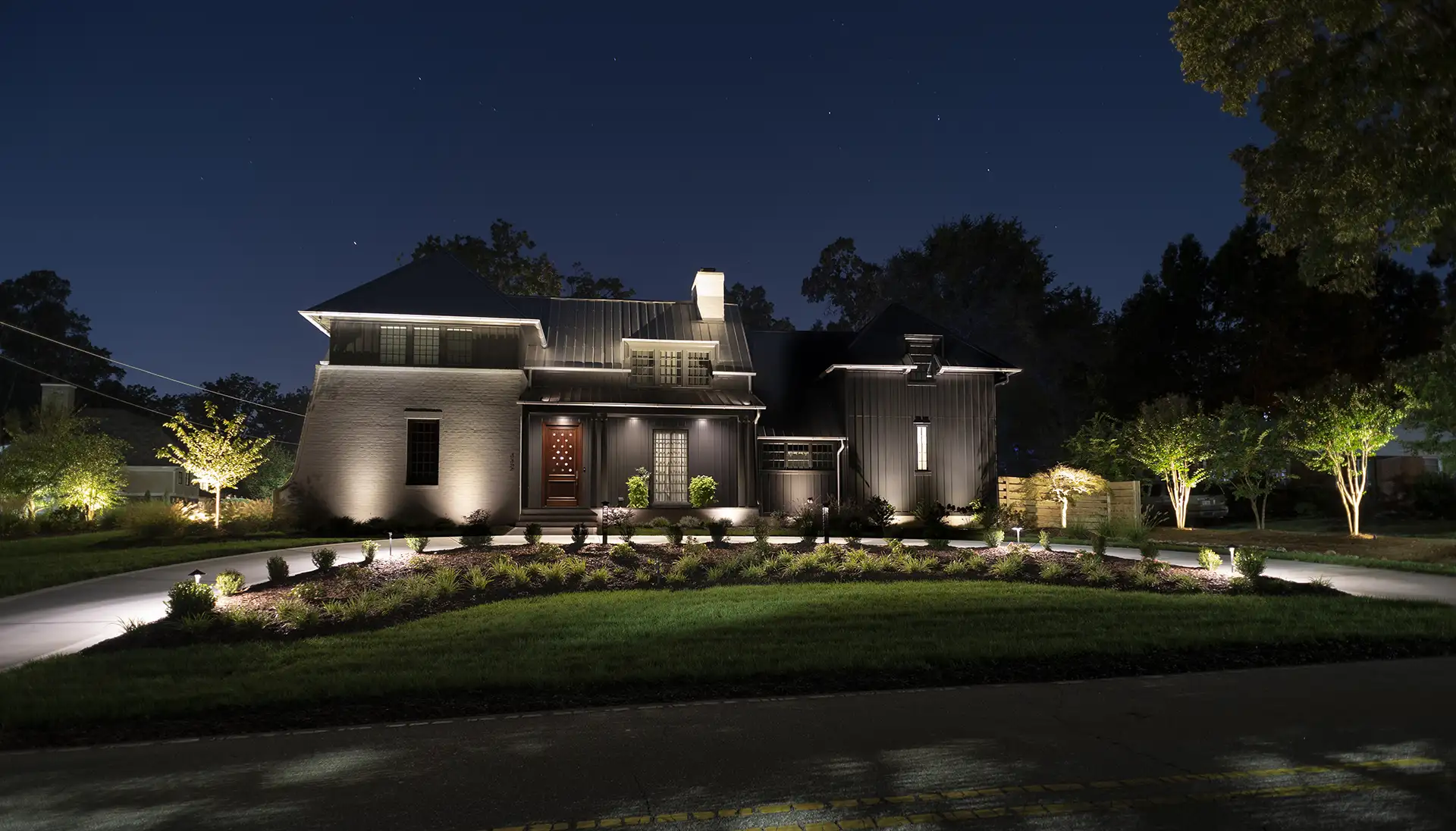 Raleigh Contemporary image 3 front view driveway night Lighthouse Outdoor Lighting and Audio Greensboro NC